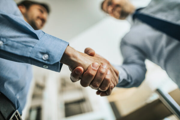 Business owners shaking hands after successful sale agreement